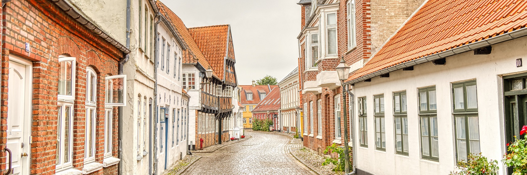 Pittoresk dansk stadsmiljö med gamla hus a kullerstensgata.