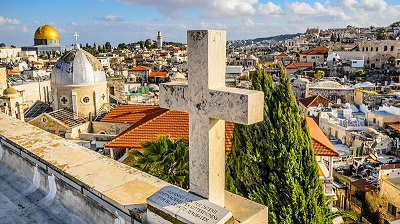 Takvy frn gamla stan i Jerusalem med ett stenkors i frgrunden.